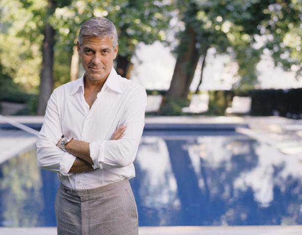 George Clooney poolside at his villa in Lake Como, not leaving anytime soon. © Omega S.A. George Clooney poolside at Villa Oleandra